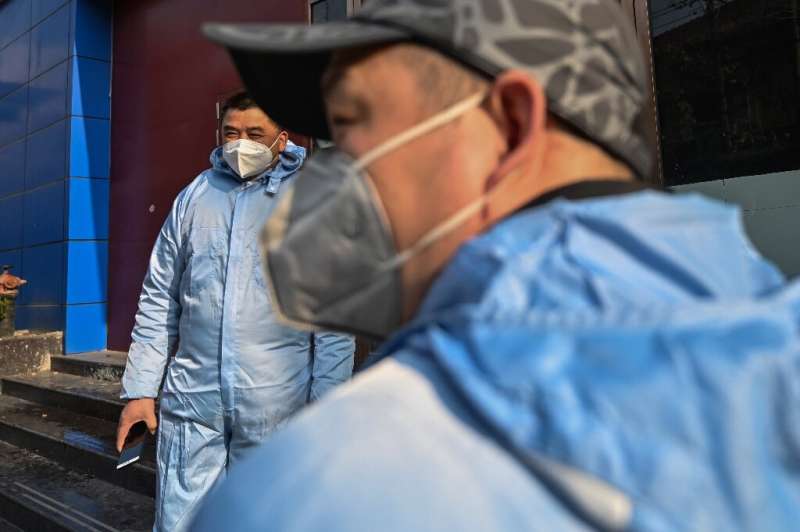 Taxi drivers wearing protective clothing in Wuhan, where the outbreak began