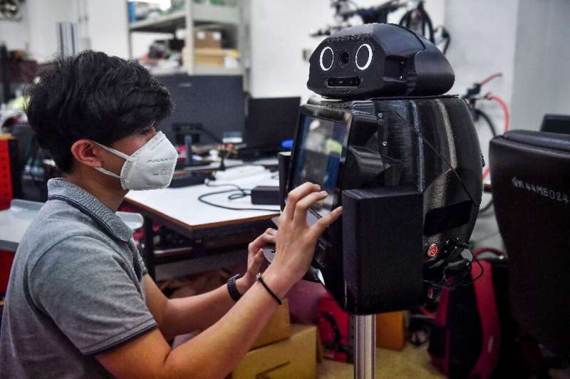 Thai hospitals are deploying &quot;ninja&quot; robots to measure fevers and protect the health of overburdened medical workers o