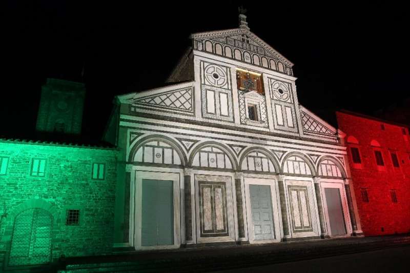 The Basilica di San Miniato al Monte illuminated with the colors of the Italian flag in Florence, Italy