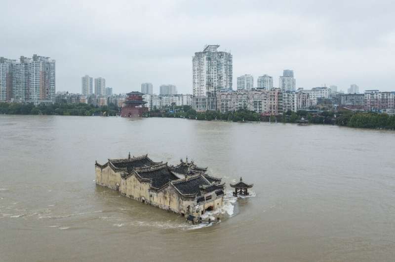 The Guanyinge temple, a 700-year old structure built on a rock in the Yangtze River in Wuhan, is surrounded by flood water