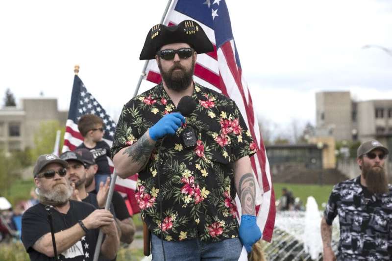 The &quot;Boogaloo&quot; movement (supporters pictured April 2020 in Olympia, Washington), which has adopted Hawaiian shirts as 