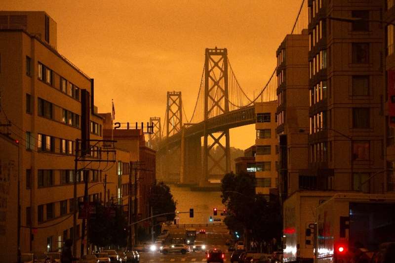 The San Francisco Bay Bridge is seen along Harrison Street under an orange smoke-filled sky in San Francisco, California on Sept
