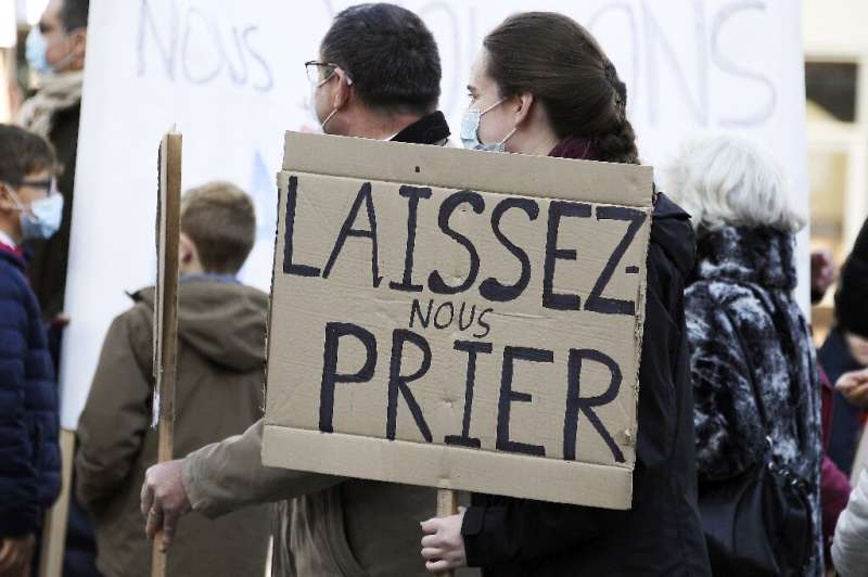 Tighter restrictions have led to sporadic protests like one in Strasbourg, eastern France. The sign says &quot;let us pray&quot;