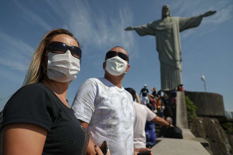 Tourists enjoy a visit to the Christ the Redeemer statue in Rio de Janeiro, Brazil, on August 15, 2020, during the reopening day