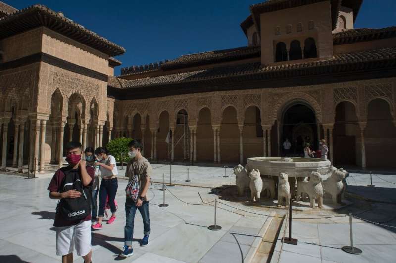 Tourists visit the Court of the Lions (Patio de los Leones) at the Alhambra in Granada on the day it reopened after three months