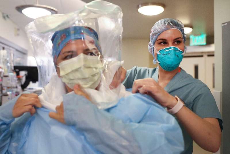 Two critical care nurses don protective equipment at Sharp Grossmont hospital in La Mesa, California