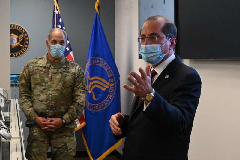 US Health and Human Services Secretary Alex Azar (R) and General Gus Perna visit the Operation Warp Speed Vaccine Operation Cent