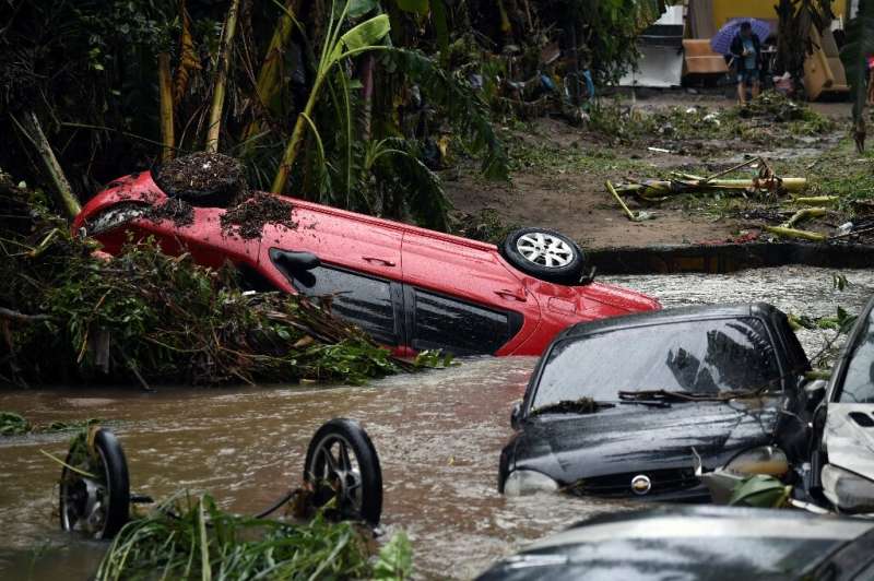 View of cars stuck in the water and mud, after heavy rains during the weekend in Realengo neighbourhood, in the suburbs of Rio d