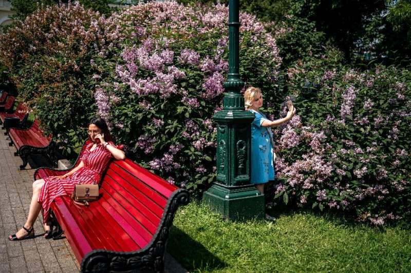 Women enjoy a warm and sunny day in a park in downtown Moscow on June 9, 2020, after officials lifted coronavirus restrictions