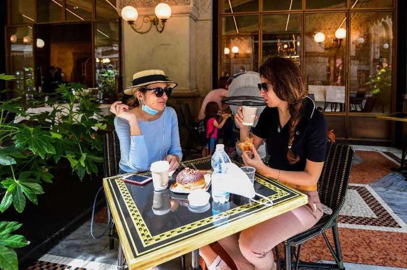 Women have coffee and pastry at Cafe Some Milan residents availed themselves of the chance to enjoy a coffee and pastry on a caf