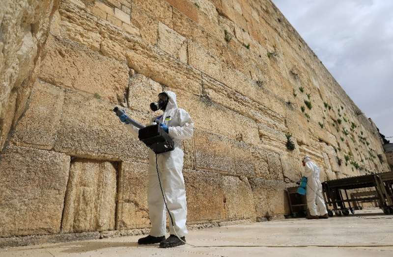 Workers sanitise the Western Wall, the most holy site where Jews can pray against the spread of the coronavirus COVID-19 in Jeru