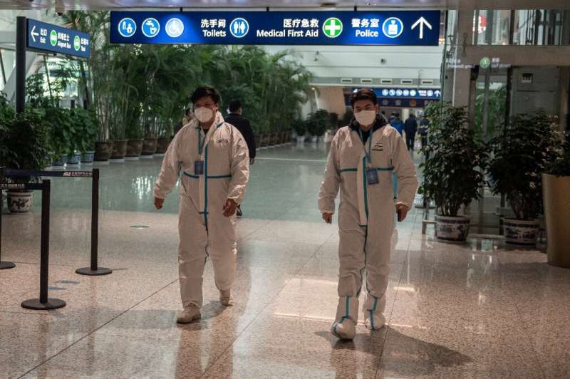 Health workers were waiting to meet the WHO team as they arrived in Wuhan on Thursday ahead of their probe into the origins of t