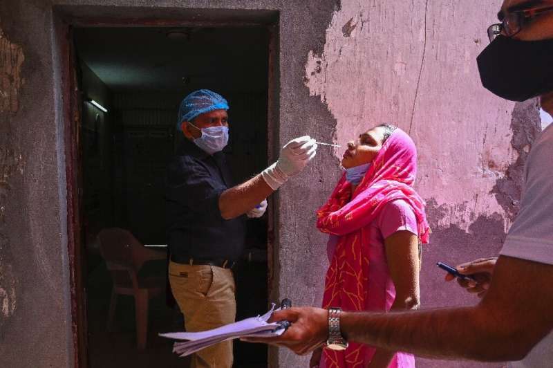 A medical worker performs a Covid test in Ghaziabad, India on April 3, 2021