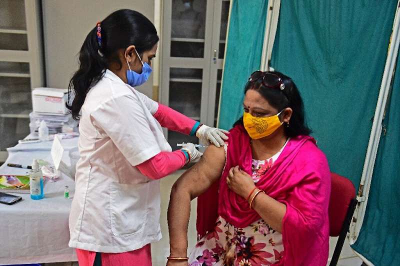 A medical worker inoculates a woman in Allahabad, India. The country is suffering a shortage of vaccines.