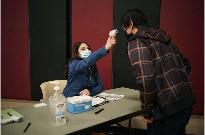 Volunteers are key at vaccine sites. It pays off with a shot