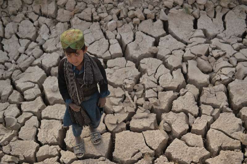 A child stands on a dry land in Bala Murghab district of Badghis province. Drought stalks the parched fields around the remote A