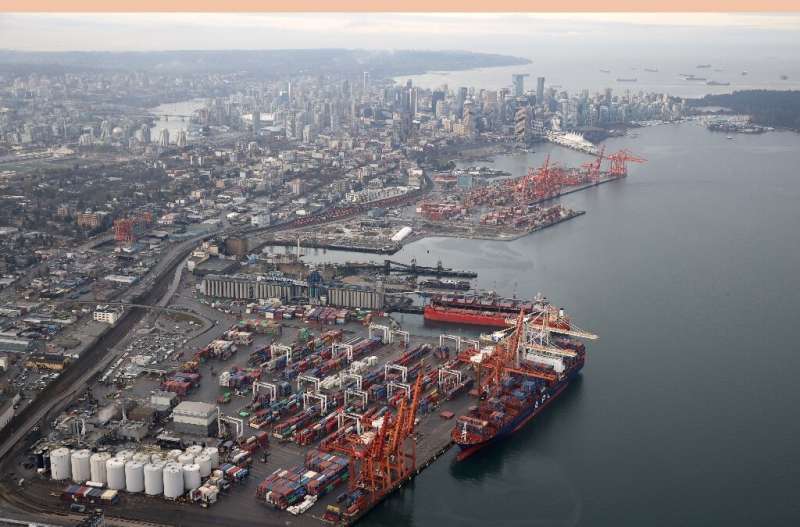 A container ship sits docked at the Port of Vancouver in November 2021 as dozens of ships wait in the harbour to pick up and unl