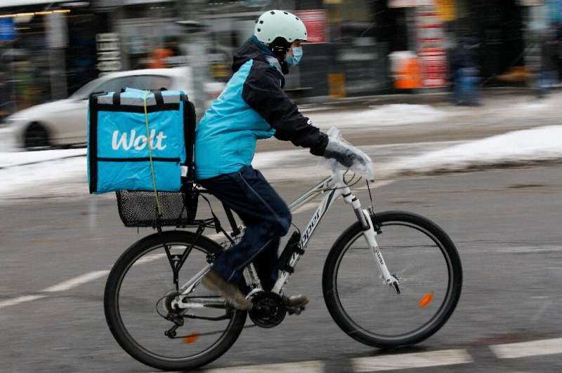 A courier working for Wolt cycles through Berlin in February 2021
