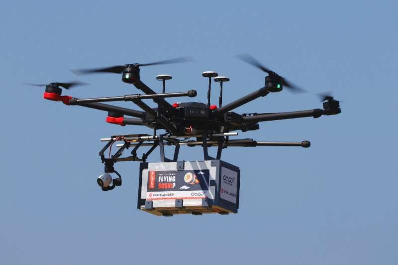 A drone carrying a box marked &quot;Flying Sushi&quot; is airborne in the Israeli coastal city of Herzliya