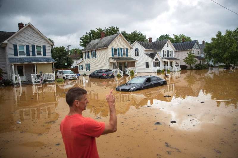 A evacuated resident, points towards his home in Helmetta, New Jersey following a flash flood caused by Tropical Storm Henri on 