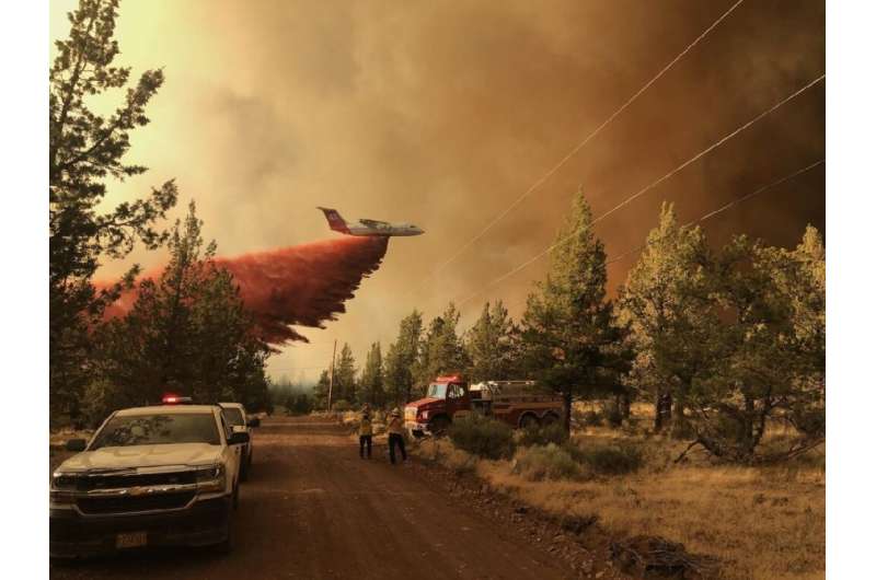 A firefighting tanker drops a retardant over the Grandview fire near Sisters, Oregon on July 11, 2021