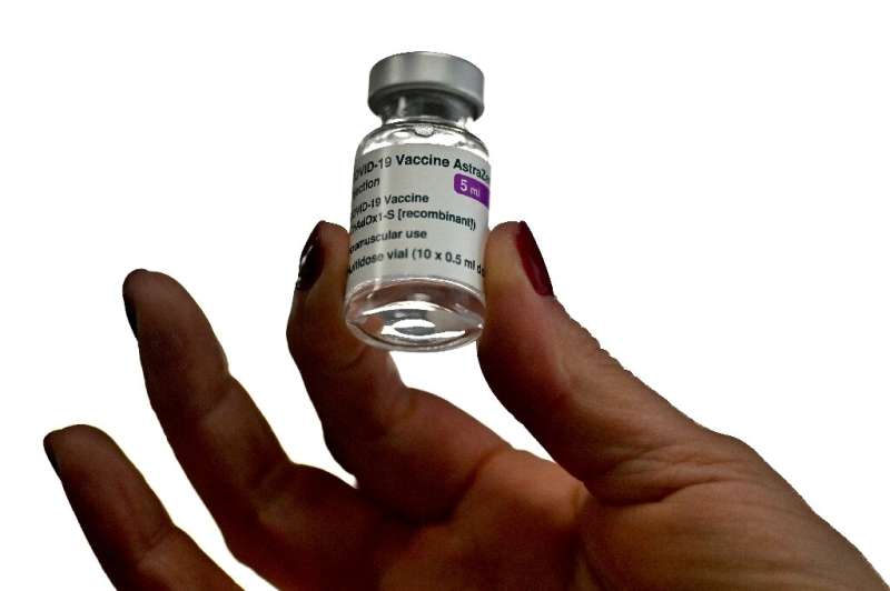 A health worker holds a vial of the AstraZeneca vaccine