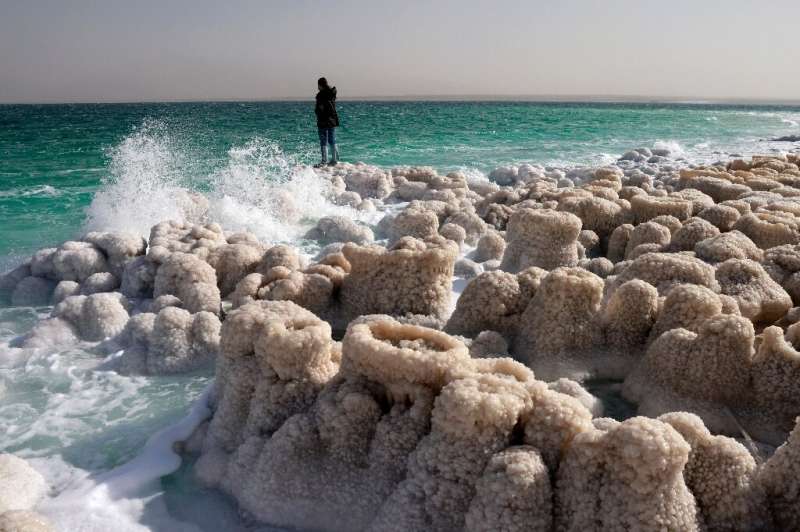 A hiker stands atop crystalised minerals in the Israeli Kibbutz Ein Gedi area on the shores of the Dead Sea