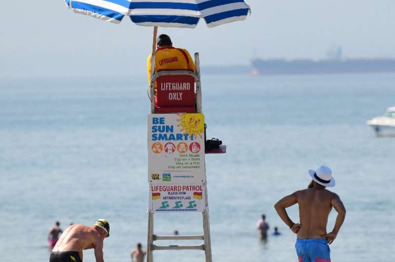 A lifeguard watches over Kits Beach, which is popular on hot days, in Vancouver