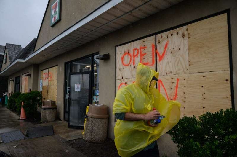 A man walks outside a convenience store as Tropical Storm Henri approaches, in Montauk, Long Island on August 22, 2021