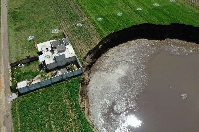 A sinkhole is threatening to swallow a house in the Mexican state of Puebla