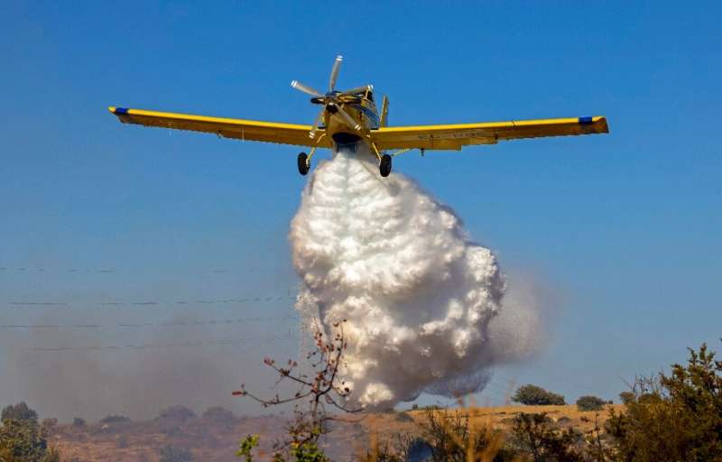 A Spanish Air Tractor firefighting plane dumps water on the southern slopes of the Troodos mountains close to Agioi Vavatsinias 
