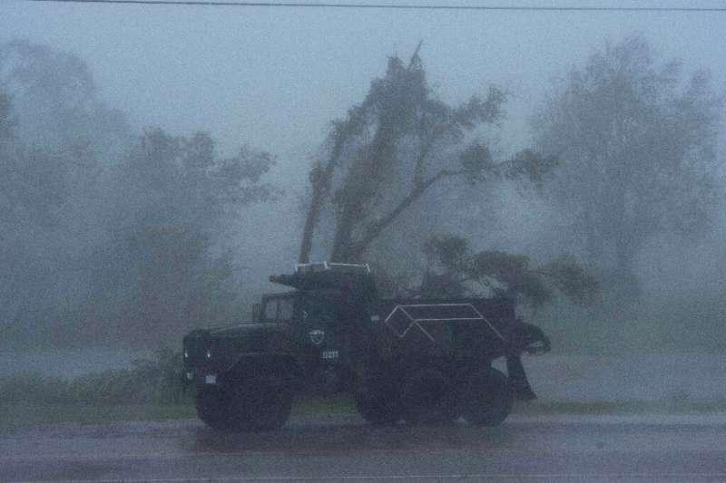 A truck is seen in heavy winds and rain from Hurricane Ida in Bourg, Louisiana on August 29, 2021