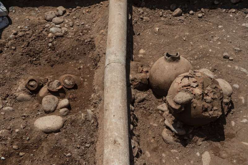 A work crew laying a natural gas pipe under a street in Lima, Peru stumbled across a 2,000-year-old burial site, including the r