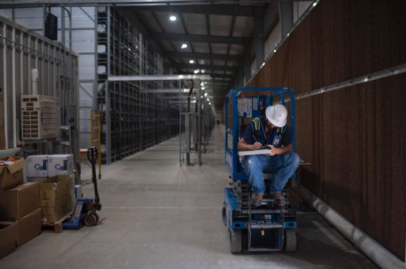 A worker fills out a form at the Whinstone US Bitcoin mining facility in Rockdale, Texas, on October 10, 2021