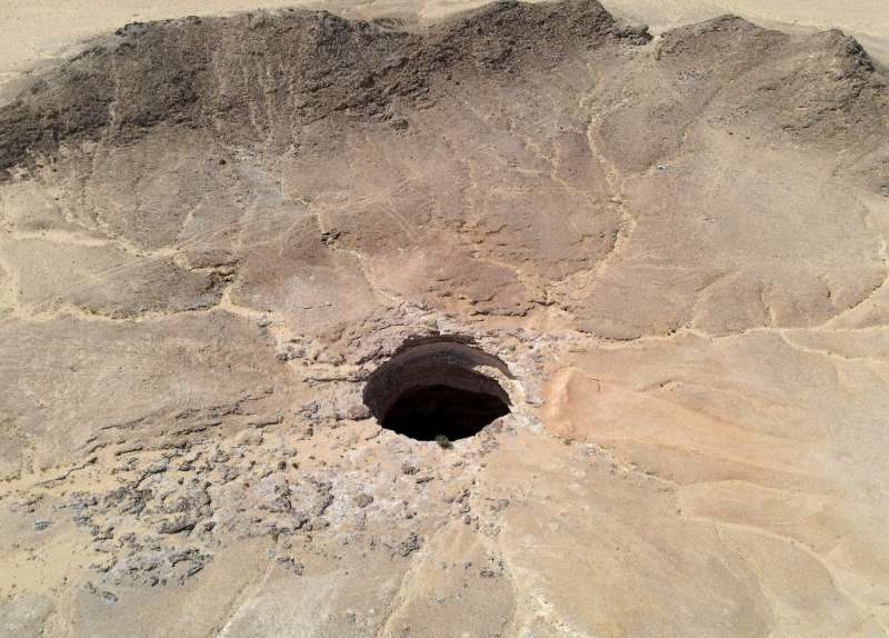 An aerial picture shows the Well of Barhout—known as the &quot;Well of Hell&quot;—in the desert of Yemen's Al-Mahra province