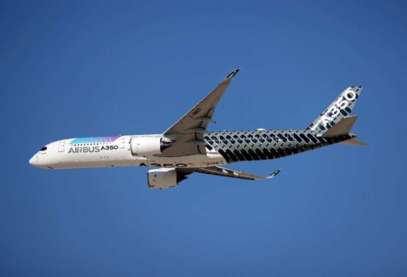An Airbus A350 XWB aircraft performs a demonstration flight at the 2021 Dubai Airshow in the Gulf emirate on November 15, 2021
