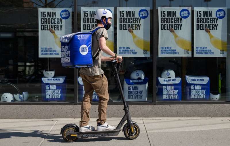 An employee rides a scooter to deliver groceries from 'Fridge No More' in Brooklyn