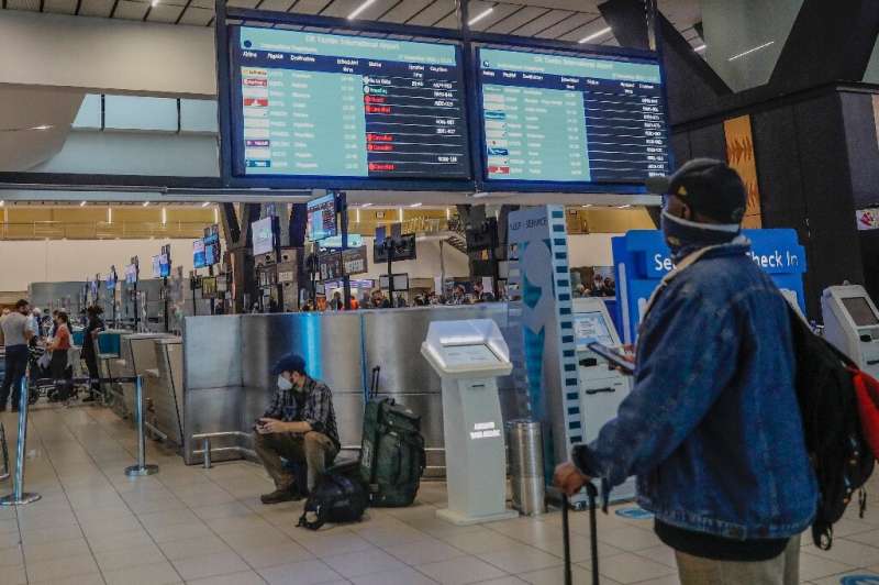 Anxious travellers thronged Johannesburg international airport, desperate to squeeze onto the last flights to countries that had