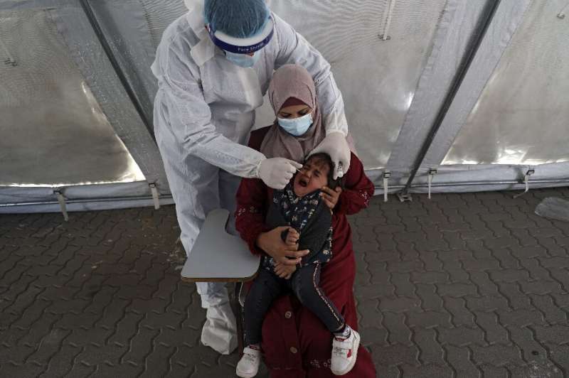 A Palestinian health worker administers a Covid test on April 1, 2021
