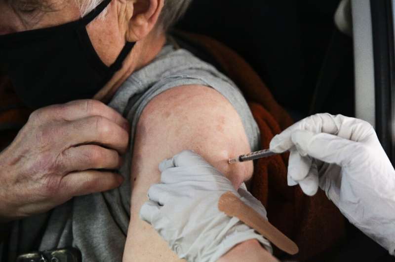 A patient receives a drive-up COVID-19 vaccination in the US state of Washington as the country tries to get on top of its massi