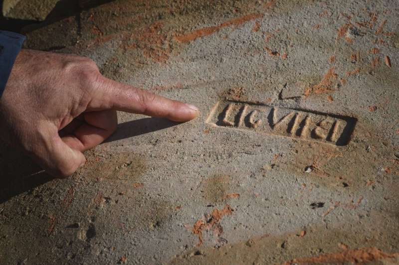 Archeologist Dragan Jacanovic points out a brick bearing a Roman stamp—for centuries, locals have used the bricks, mosaic tiles 