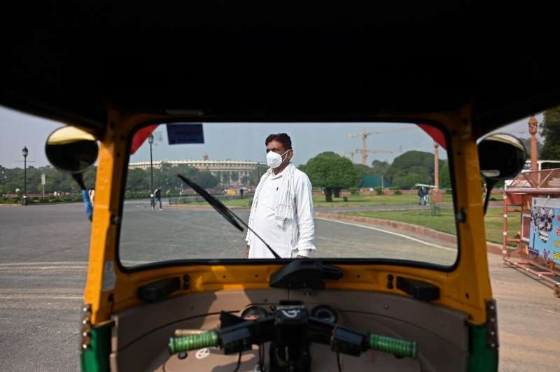 Auto rickshaw driver Bhajan Lal navigates the Indian capital's chaotic roads and poisonous air