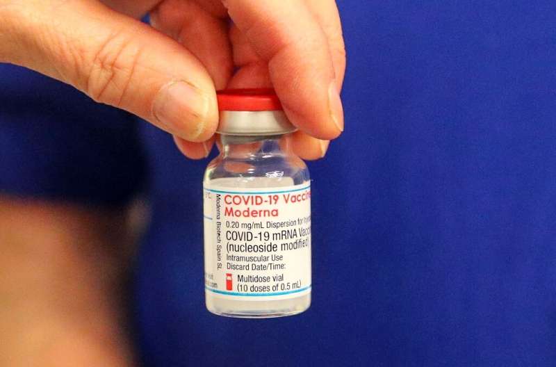 A vial of the Moderna Covid-19 vaccine is prepared at the Madejski Stadium in Reading, west of London