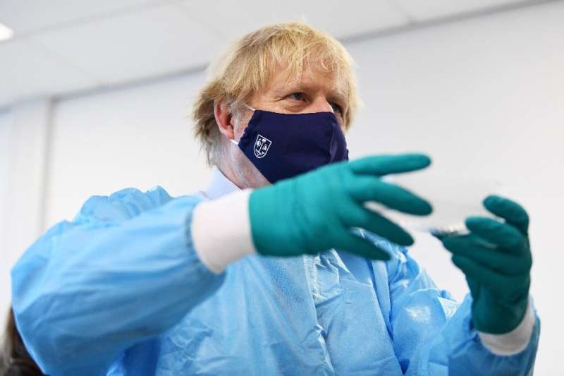 Britain's Prime Minister Boris Johnson visits a Covid testing lab in Scotland