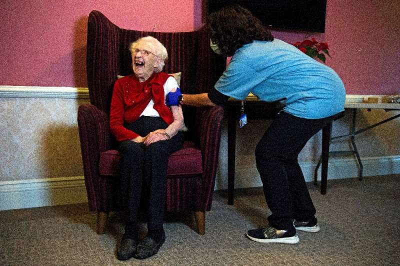 Ellen Prosser, 100, receives the Oxford/AstraZeneca vaccine in London on January 7