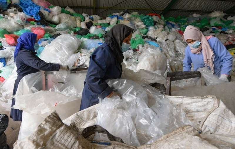 Employees sort through piles of plastic waste at African Recycling, one of the few recycling companies in Tunisia