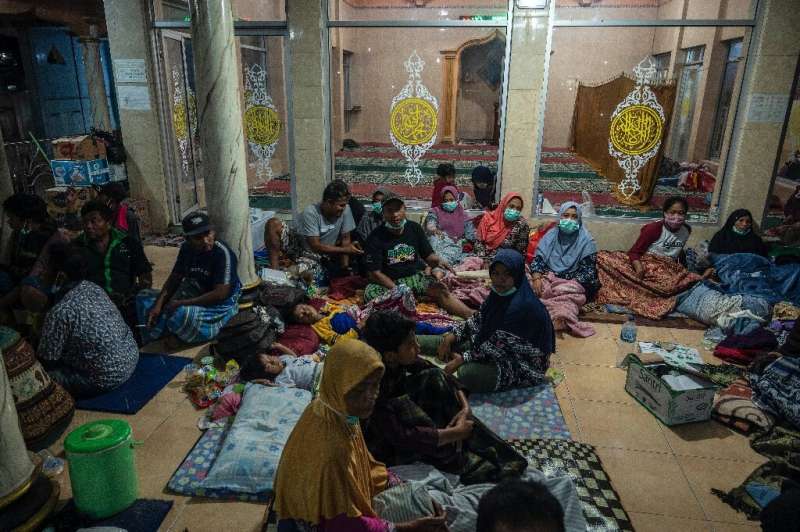 Evacuees take shelter at a mosque in Lumajang after the eruption of Mount Semeru