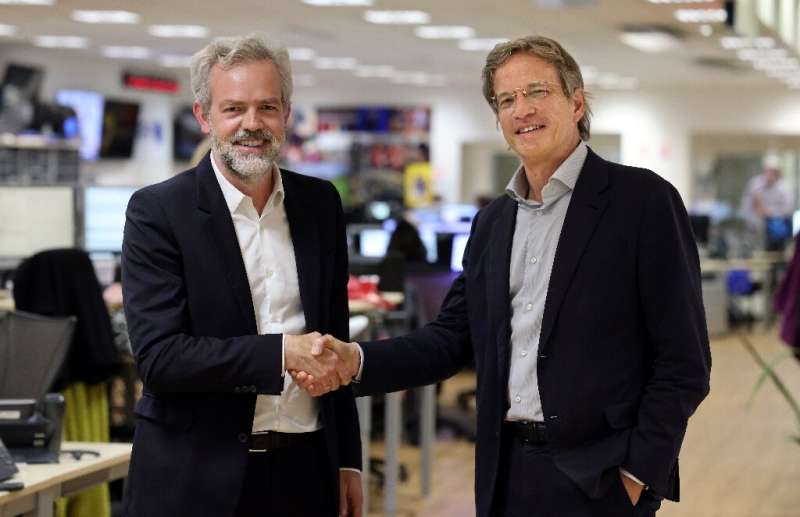 Google's Sebastien Missoffe (left) and Fabrice Fries reach what the AFP CEO described as a 'pioneering' agreement for the search