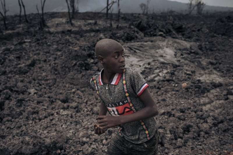 In the shadow of Nyiragongo: A child in the northern outskirts of Goma runs on a bed of solidified lava