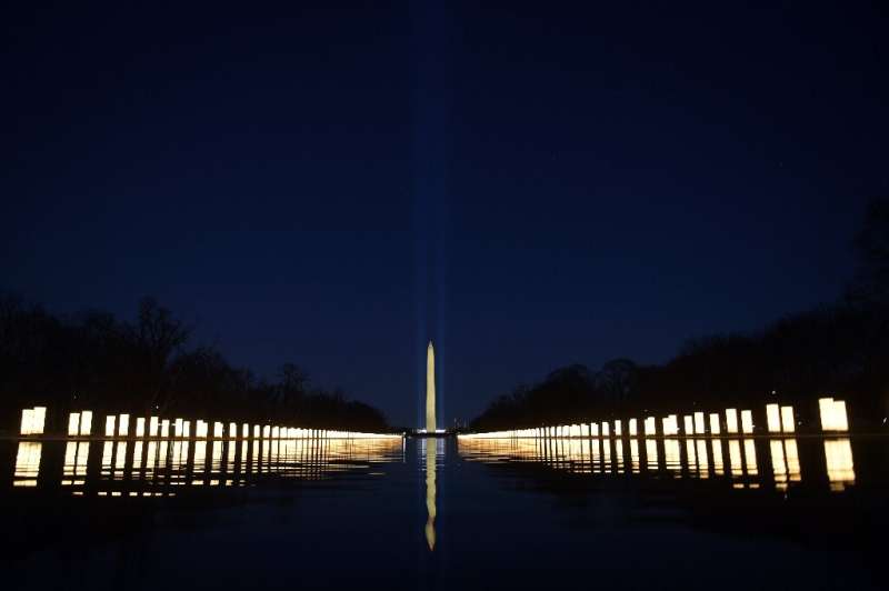 In Washington, the lights of the Reflecting Pool were turned on in tribute to American victims of the pandemic